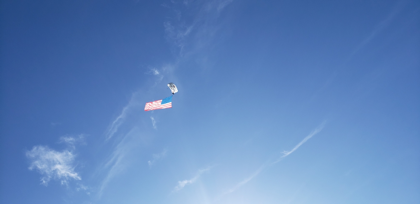 Flag sky dive drop to start tournament for the 14th Annual Freedom Fighters Open golf tournament in 2020. Tournament helps raise money to provide gifts and scholarships to children of deployed military service members.